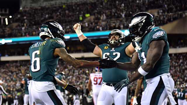 Jason Kelce celebrates with receivers DeVonta Smith and A.J. Brown